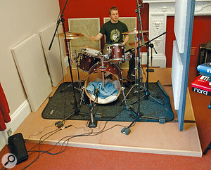 A less intrusive alternative to constructing a full floating floor is to create something like this drum riser. Of course, playing acoustic drums at home may not be a good idea if noise is a problem, but the same principle can reduce mechanical noise transmission through wooden floors from other instruments, including guitar amps.